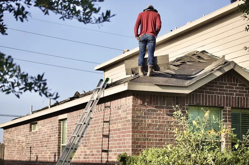 Professional roofer working on a residential roof in Mehama